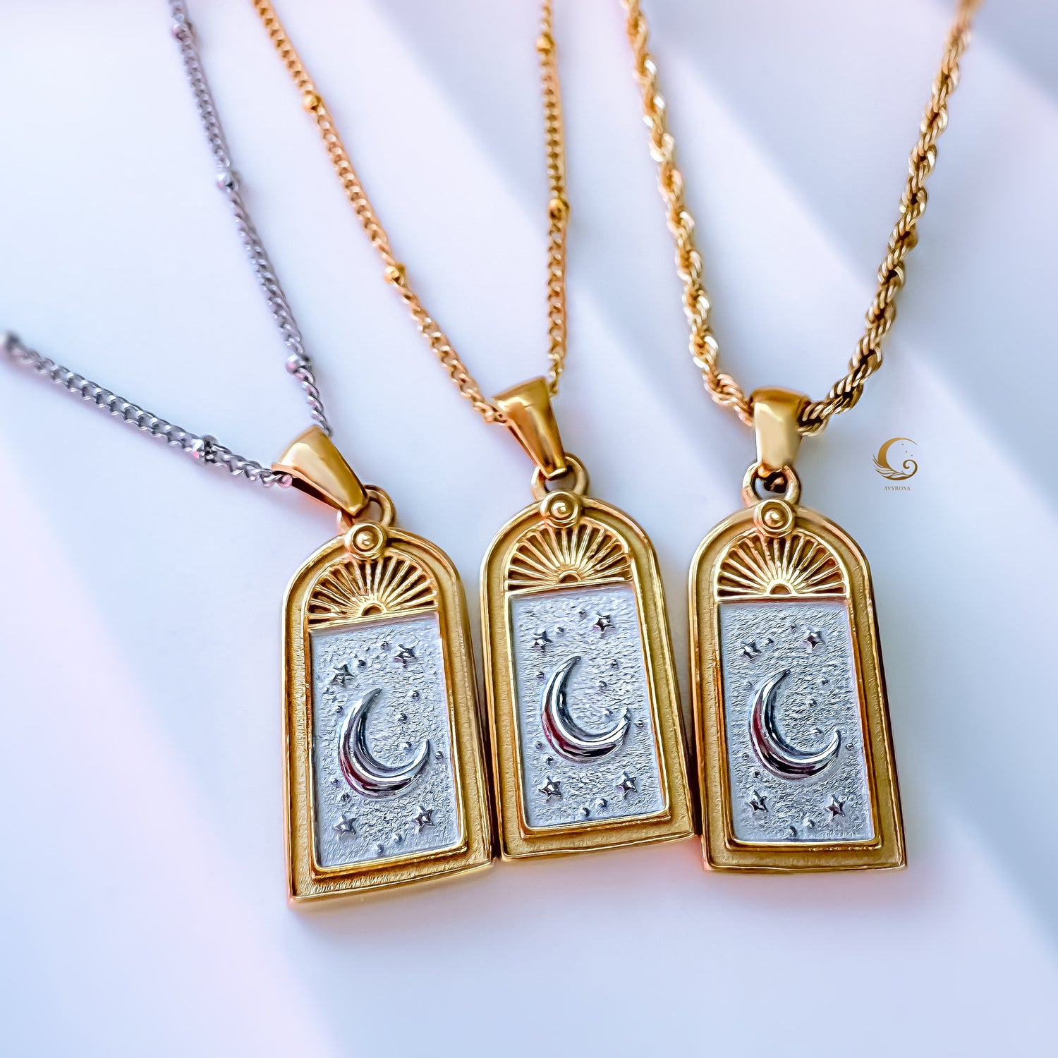 Three Selara tarot moon necklaces in 18K gold plated 316L stainless steel with silver inlay — crescent moon and star design on gold rope and silver satellite chains by Avyrona.