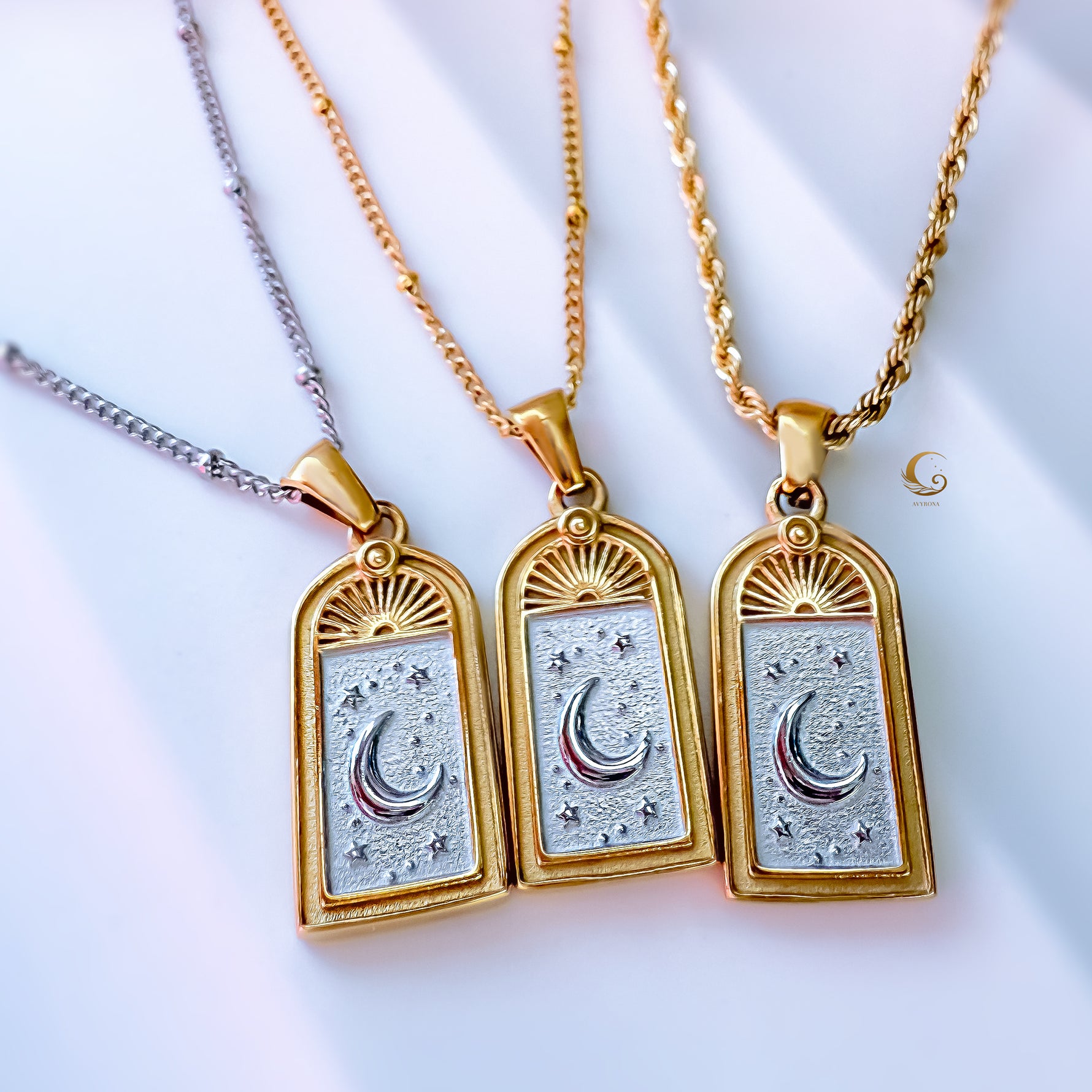 Three Selara tarot moon necklaces in 18K gold plated 316L stainless steel with silver inlay — crescent moon and star design on gold rope and silver satellite chains by Avyrona.