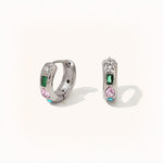 Pair of silver hoop earrings featuring multicolored zircon stones – green, pink, white, and blue – in playful shapes.