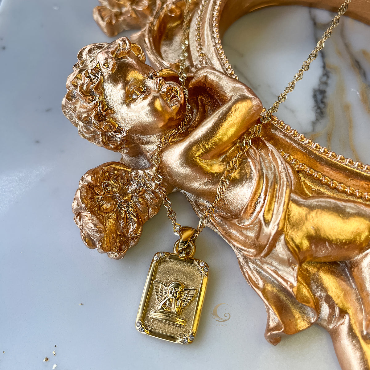 Seraphina angel tarot necklace displayed on golden cherub statue, symbolizing celestial energy