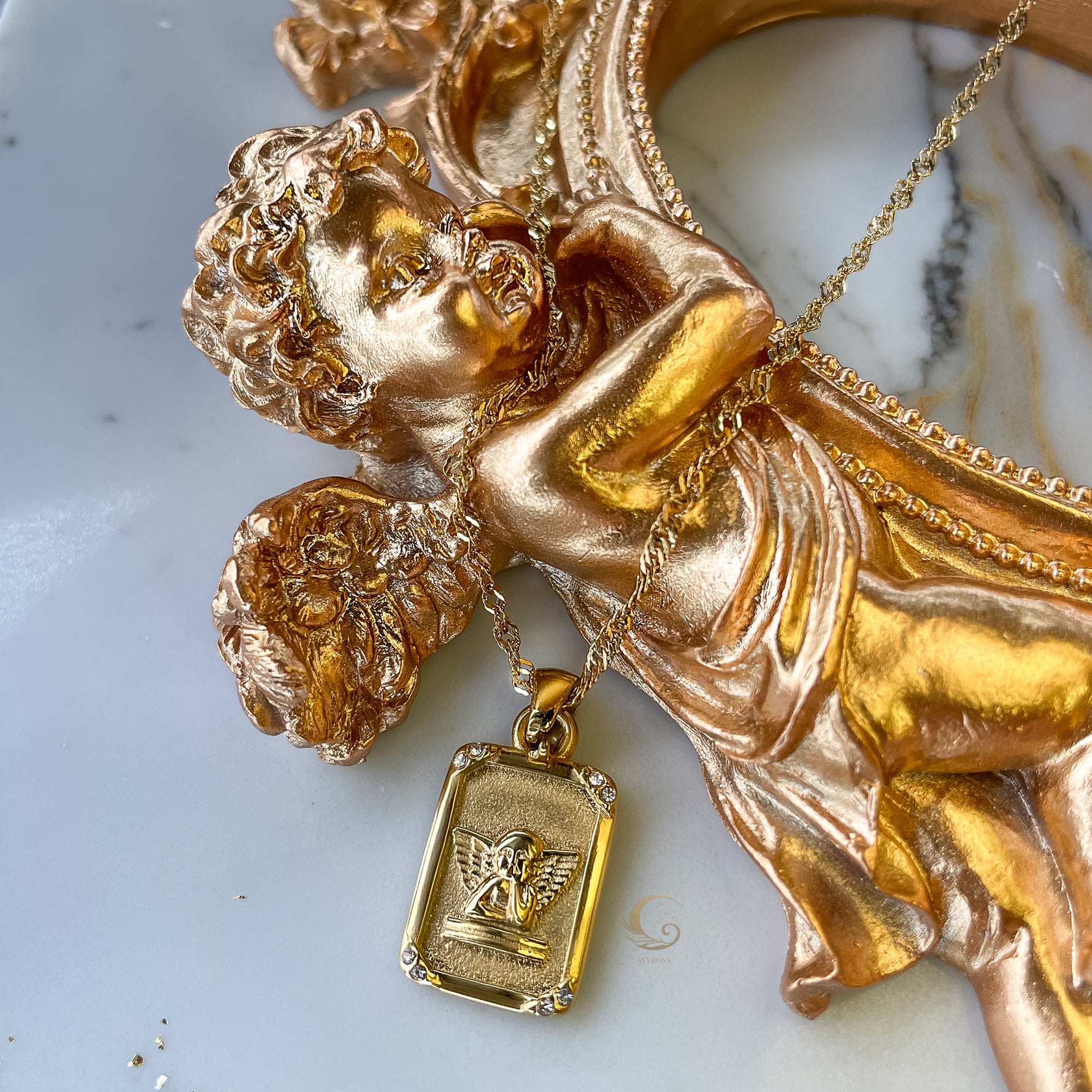 Seraphina angel tarot necklace displayed on golden cherub statue, symbolizing celestial energy