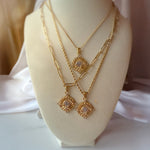 Layered celestial necklaces styled on bust — Soleia in paperclip, twisted, and classic forms