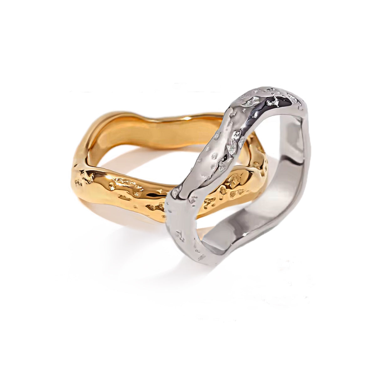 Minimalist product shot of two Wave rings – one in gold, one in silver – crossing elegantly.