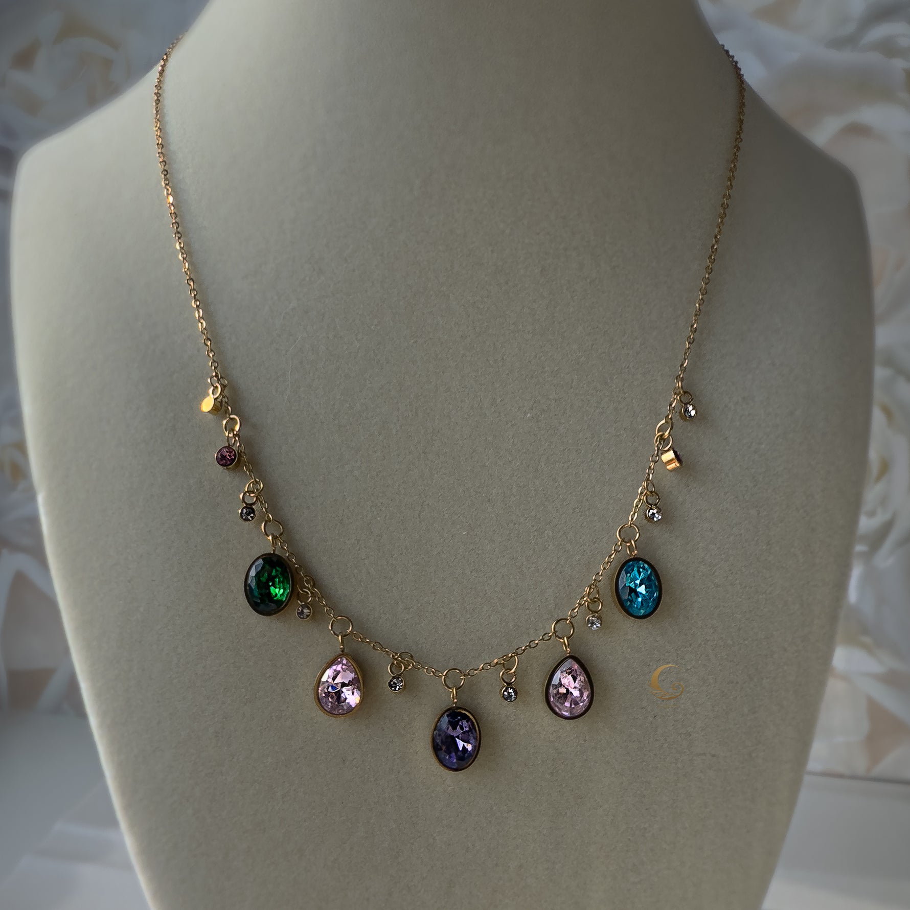 Zaria charm necklace displayed on beige bust showing full crystal layout