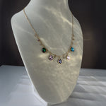  Zaria necklace glowing under soft light, displayed on mannequin