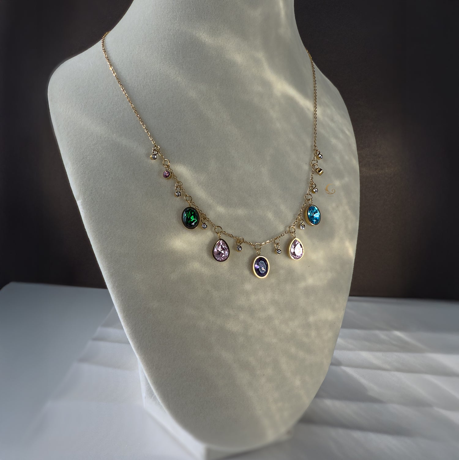  Zaria necklace glowing under soft light, displayed on mannequin